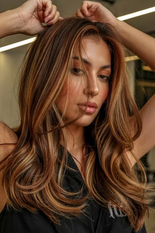 woman with brown cinnamon hair and honey highlights