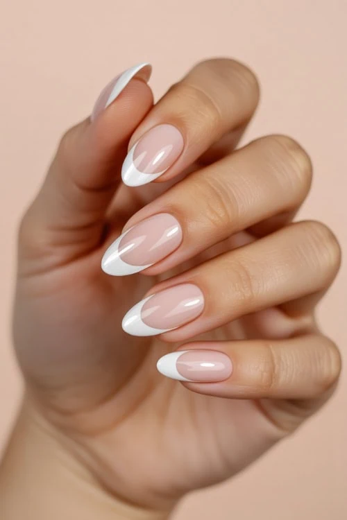 hand with french tip almond nails for a  summer manicure