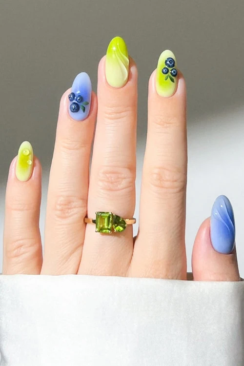 hand with fruit nails that are 3D blueberry and green