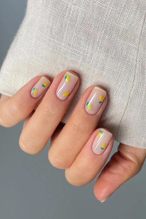 hand with short lemon fruit nails