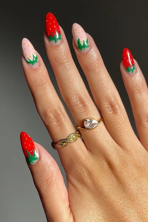 hand with strawberry fruit nails