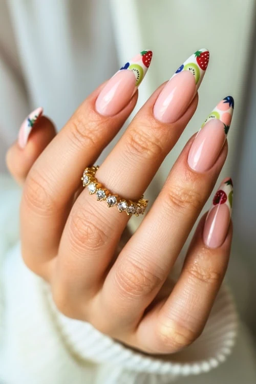 hand with fruit nails with french tips strawberry, kiwi, and blueberry
