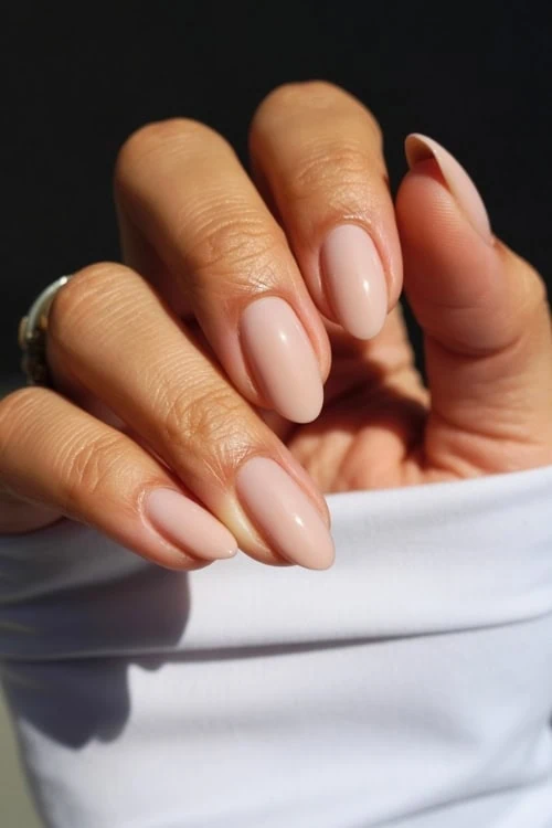 hand with short nude almond nails 