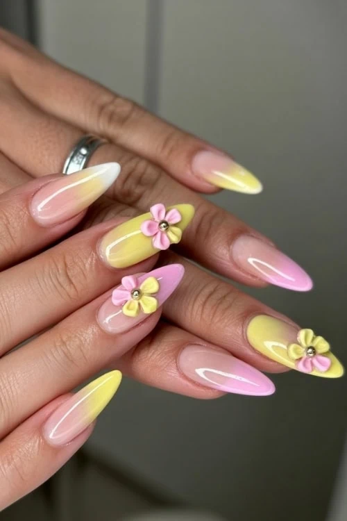 hand with a yellow and pink 3d nails design