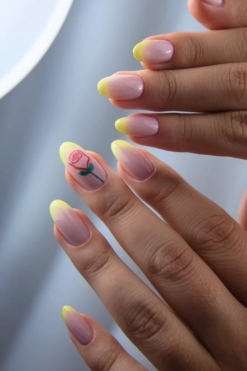 female hand with yellow nails that have a flower design