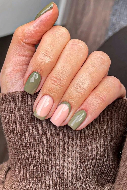 female hand with olive green fall nails