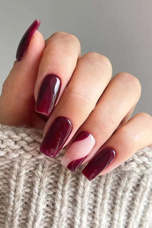 hand with merlot colored fall nails design