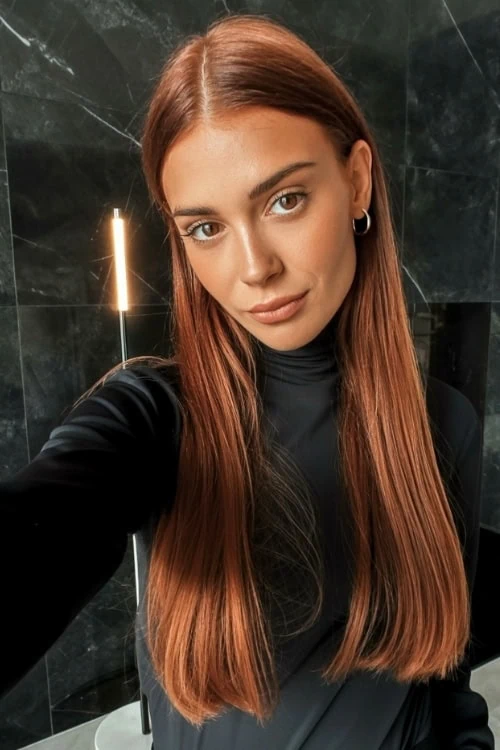 woman with long straight copper and auburn red hair