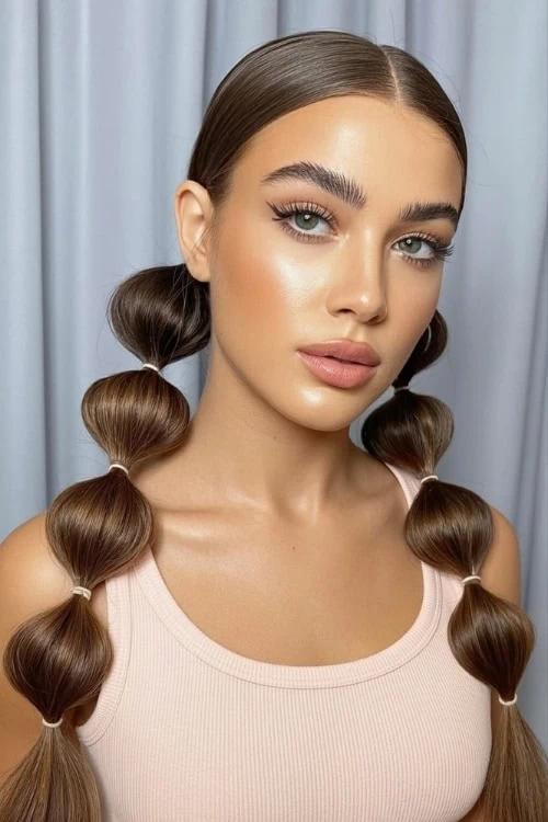 young woman with a summer hairstyle of bubble braid pigtails