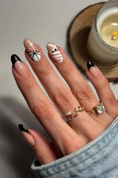 female hand with halloween themed nails in black and white