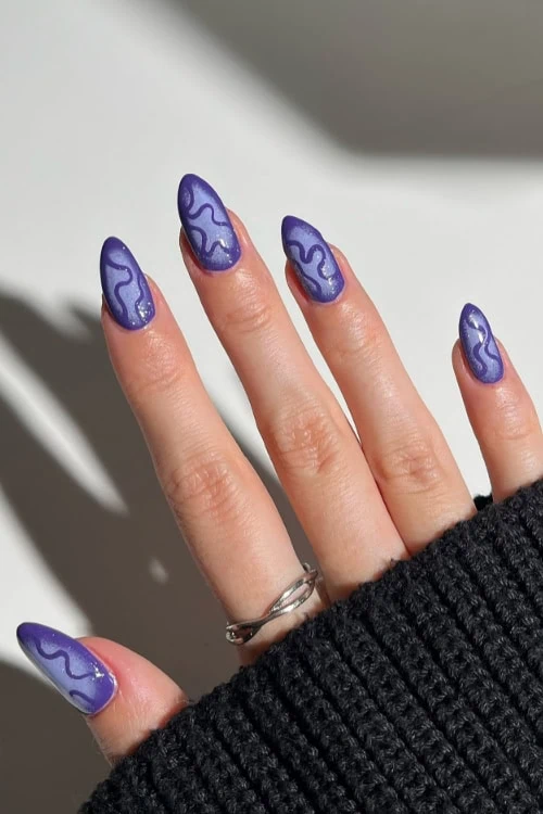 female hand with purple nails for halloween
