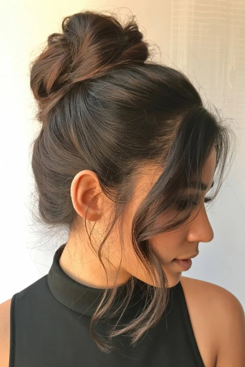woman with medium length hair in a high bun hairstyle