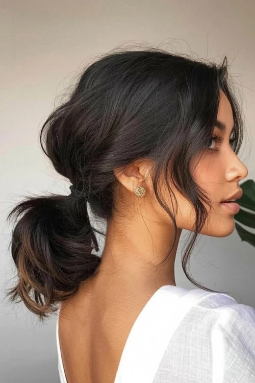 young woman with a hairstyle for medium length hair that is a low ponytail