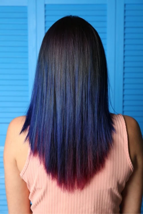 woman with a vibrant hair color that is blue burgundy ombre