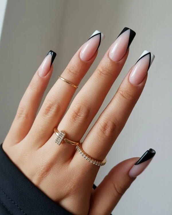 hand with Black and white V-shaped French tip Nails