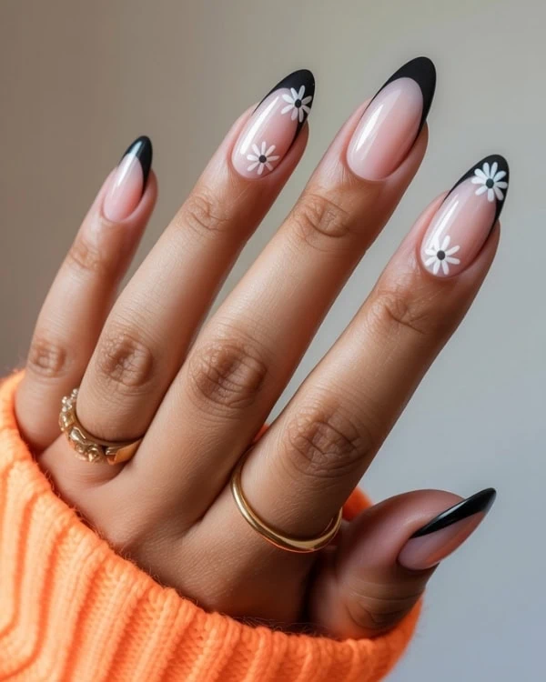 hand with Black French Tip Nails & White Flowers