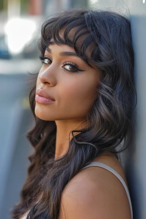 black woman with curled bangs and long hair