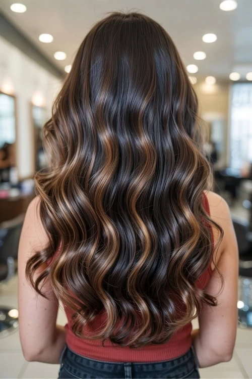 back of female's head with caramel balayage on dark hair