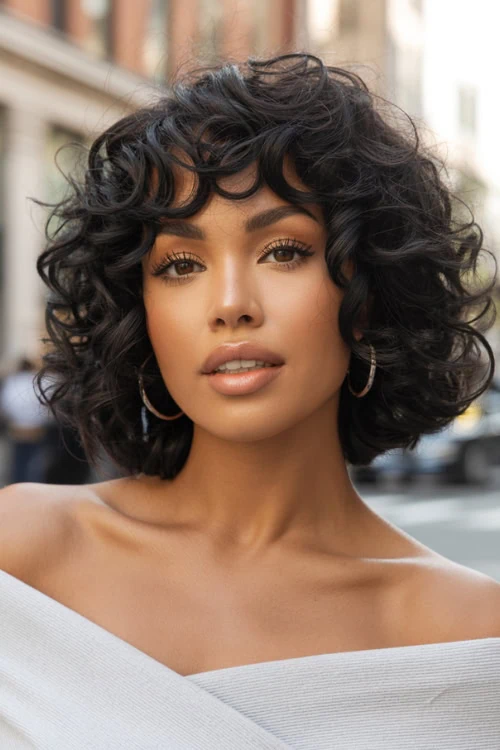woman with curly hair and bangs