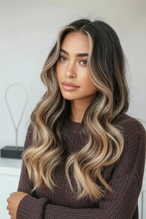 young woman with a sweater and a fall wavy loose hairstyle
