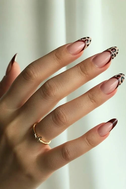 hand with leopard print brown nails