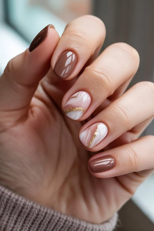 hand with marble luxe brown nails