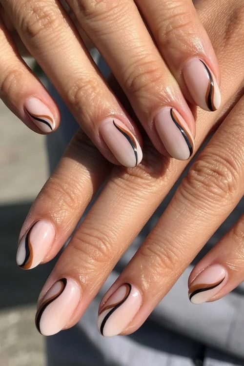 hands with nude accent brown and black nails