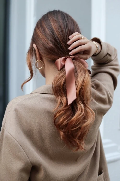 woman with a wavy ribbon tied ponytail hairstyle