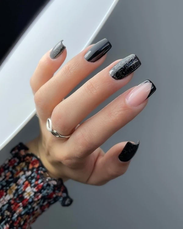 hand with shimmery black nails