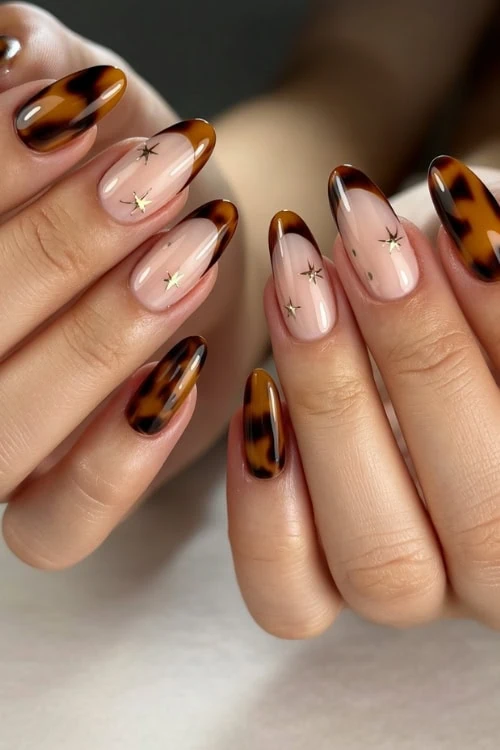 hands with tortoiseshell brown nail design manicure