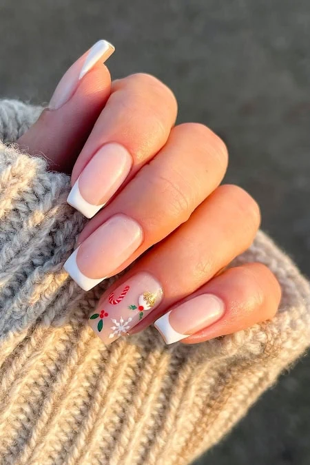 Elegant Christmas-themed acrylic manicure with French tip nails and festive nail art on holiday season.