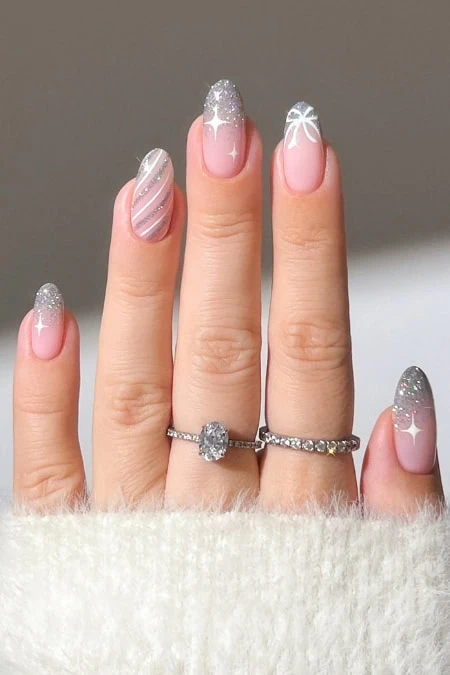 Elegant winter nail art with silver glitter and snowflake designs, perfect for Christmas holiday nails and manicure trends.