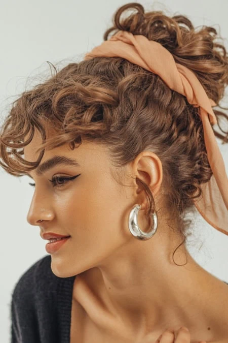 young woman with long curly hair in an updo hairstyle