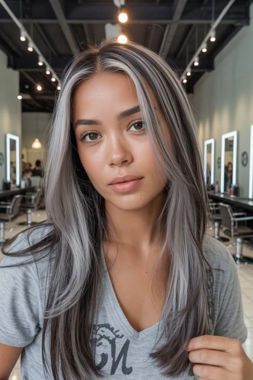 Stylish woman with silver-gray hair in a modern salon, showcasing trendy hair coloring for fall.