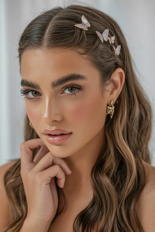 Beautiful woman with butterfly hair clips, flawless makeup, and glowing skin, featuting a summer hairstyle.