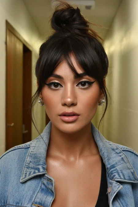 Striking woman with bold makeup, stylish black eyeliner, and casual denim jacket, showcasing a cute winter hairstyle.