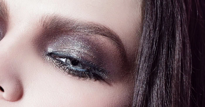 Bright silver and black eyeshadow makeup on a woman's eye, emphasizing bold eye beauty, perfect for beauty and makeup tutorials, skincare, and eye makeup tips.