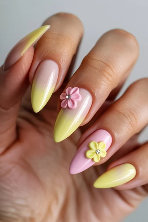 Colorful floral nail art design with pastel pink and yellow gel nails and 3D flower accents, perfect for spring and summer manicure trends.
