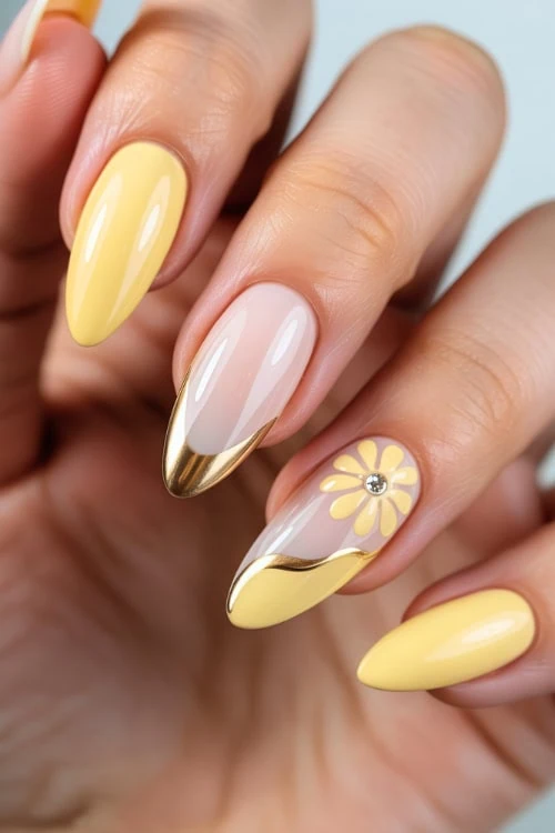 Elegant yellow and nude stiletto nails with floral and gold accents, perfect for a sophisticated and trendy manicure look at The Beauty Deep Life.