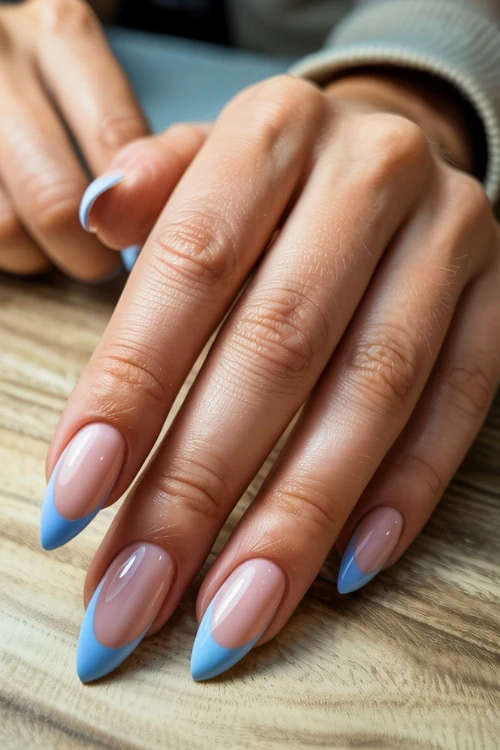 Vivid blue and natural pink ombre almond-shaped acrylic nails with glossy finish, professional french tip manicure on female hand, beauty and nail care, The Beauty Deep Life.