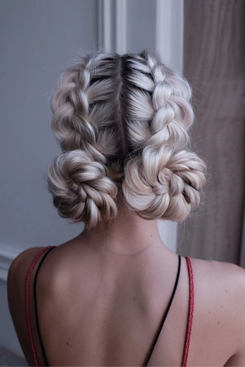 Intricate blonde braided hairstyle with soft, voluminous curls for a sophisticated and elegant look.