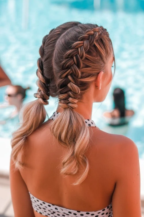 Beautiful woman with braided hairstyle by the poolside, showcasing summer beach hair and hair styling tips, perfect for summer beauty and hair care.