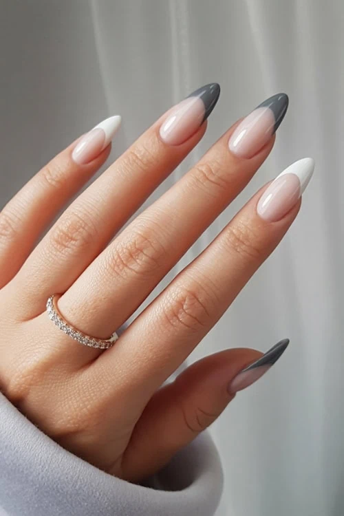 Elegant almond-shaped nude and gray acrylic french tip nail design with a dainty diamond ring, perfect for modern beauty and nail art inspiration.