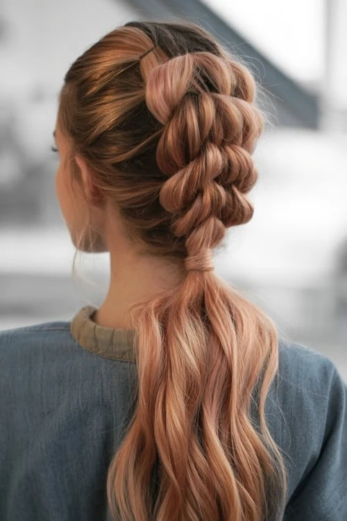 Elegant braided and wavy ponytail hairstyle with rose gold hair color, perfect for bridal or formal occasions. Beautiful hair styling ideas for women.