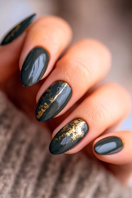 Elegant black and gold marble nail art design with glossy finish, perfect for beauty and self-care enthusiasts. Showcasing luxurious and trendy manicure ideas.