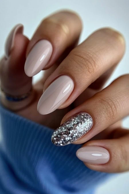 Elegant gel manicure with nude and glitter accent nails, perfect for beauty and nail art enthusiasts. on new years.
