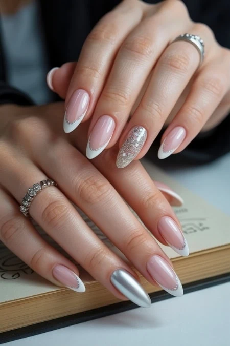 Elegant manicured hands showcasing stylish gel nails with silver accents and a glittery ring finger, perfect for beauty and nail art enthusiasts.