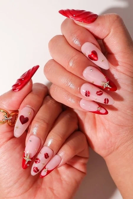Elegant Valentine's Day themed acrylic nails with red and pink hearts, gold accents, and intricate designs, perfect for glamorous and romantic nail art styles.