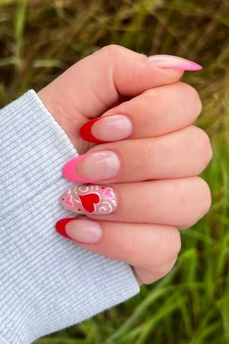 Elegant Valentine's Day-inspired nail art with pink and red French tips and heart designs on natural nails, ideal for beauty, nail art tutorials, and special occasions.