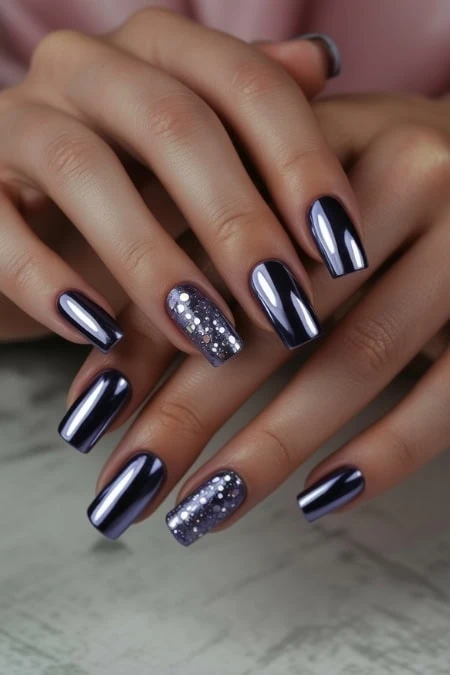 Dark navy blue gel manicure with glitter accent nails featuring silver and white dots for a stylish, modern nail design. Perfect for elegant and trendy fashion statements on new years.